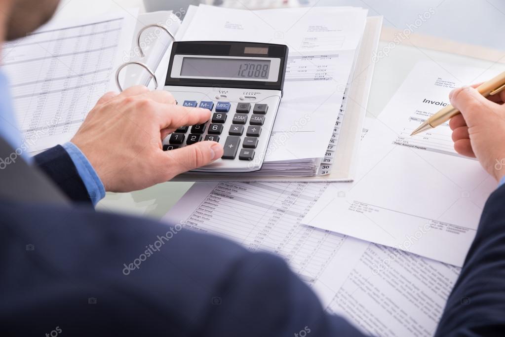 Businessman Calculating Invoices