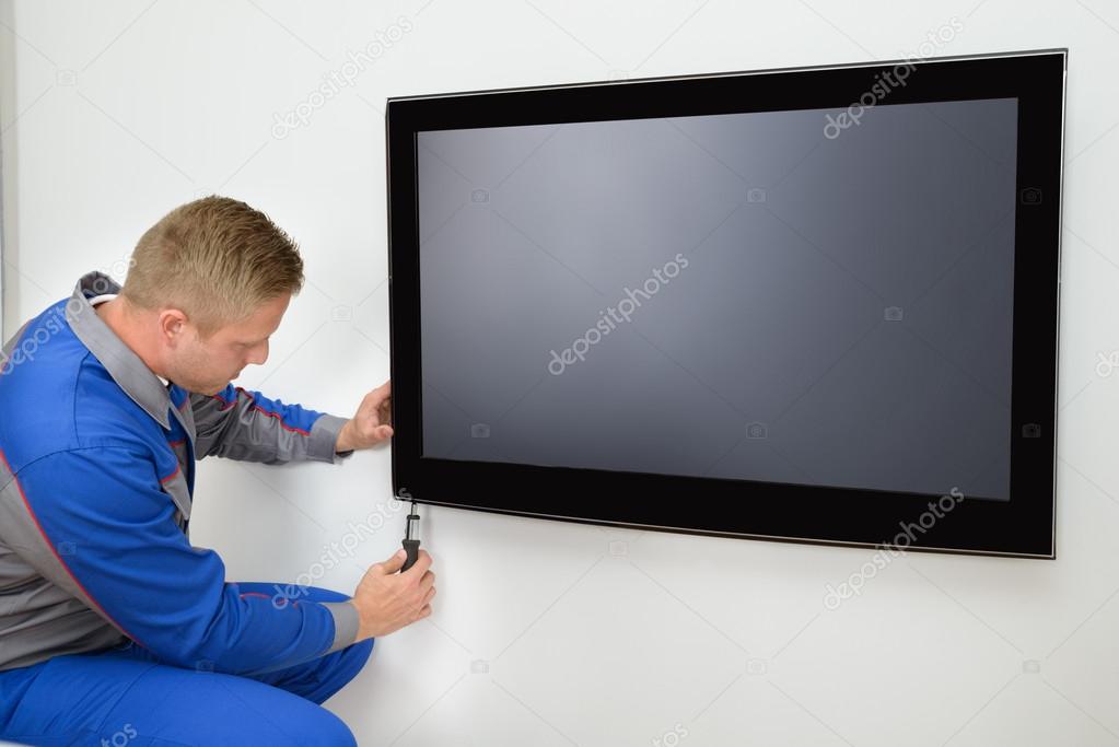 Technician Repairing Television