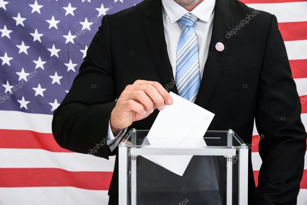 Person Putting Ballot In Box