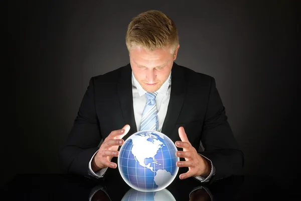 Businessman Looking At Globe — Stock Photo, Image