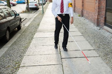 Blind Man Walking On Sidewalk clipart