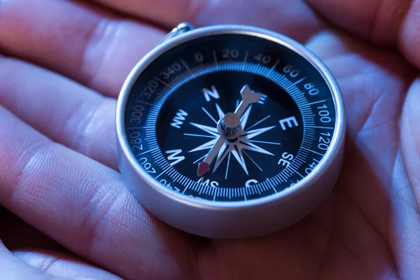 Svart kompass i hånden – stockfoto