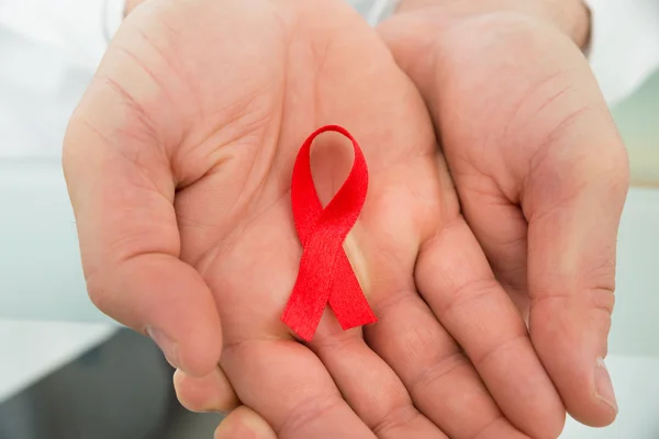 Person Holding Aids Ribbon — Stock Photo, Image