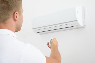 Man Operating Air Conditioner clipart