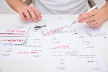 Man Calculating Unpaid Bills clipart