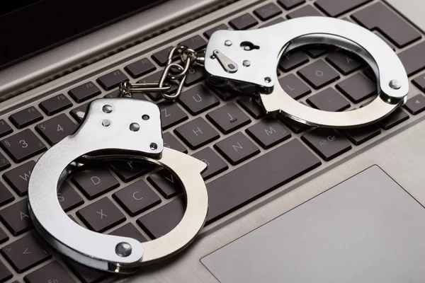 Handcuffs On Laptop Keypad — Stock Photo, Image