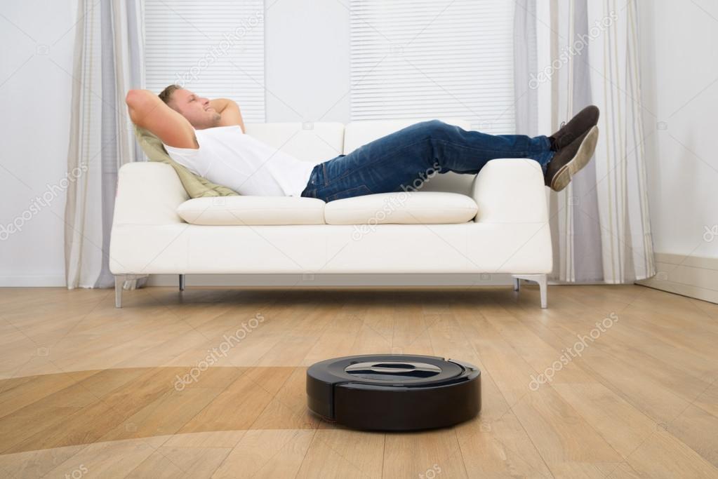Man On Sofa with Robotic Vacuum Cleaner