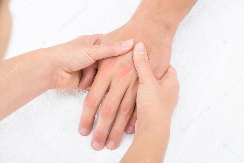 Physiotherapist Massaging Palm