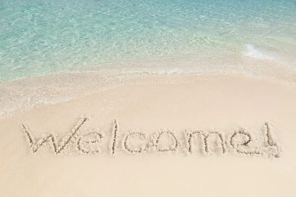 Přivítání, napsaný na písku — Stock fotografie