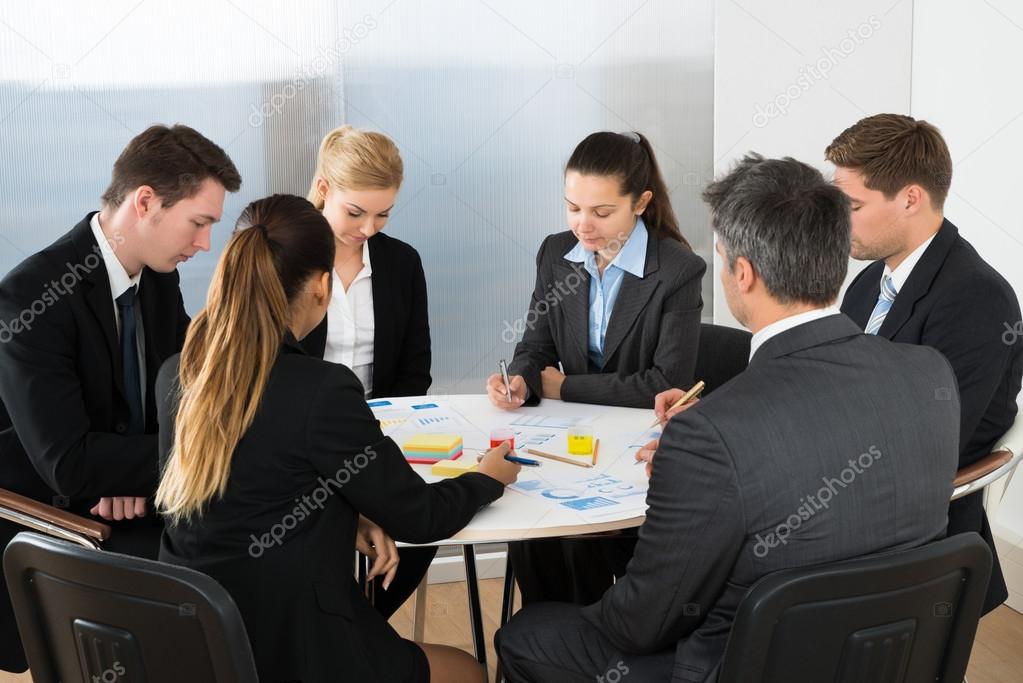 Businesspeople Analyzing Graph