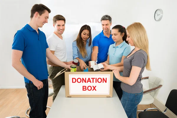 People Looking Inside Donation Box