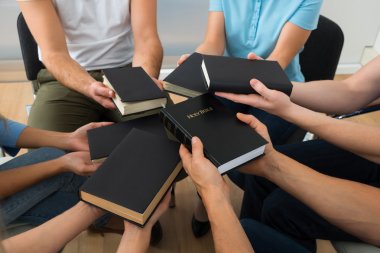 People Holding Holy Bible