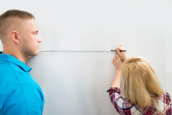 Couple Measuring Wall — Stock Photo, Image