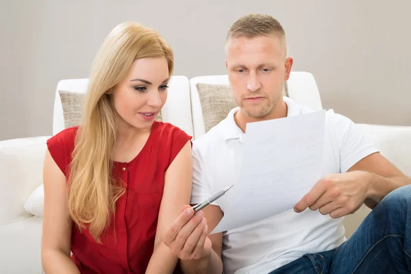 Couple Smiling Looking At Bill — Stock Photo, Image