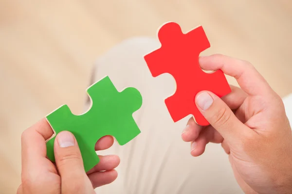 Man Joining Puzzle Pieces — Stock Photo, Image