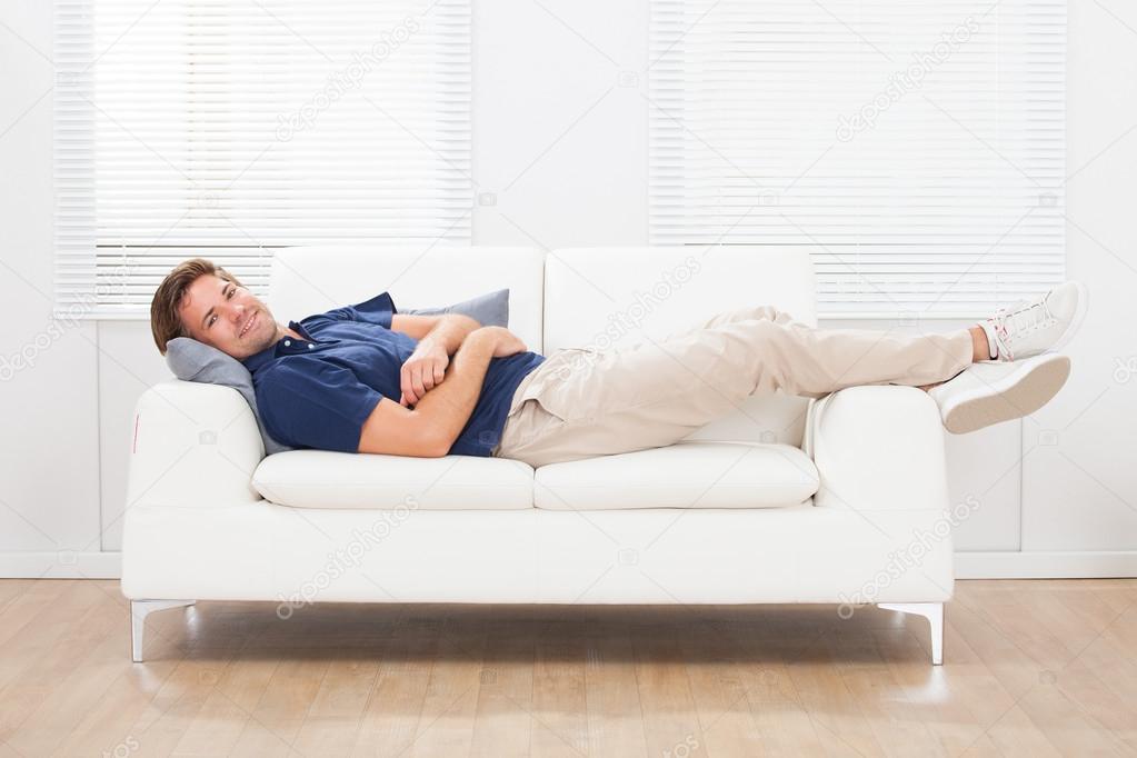 Man Lying On Sofa Home Stock Photo by ©AndreyPopov 71491863