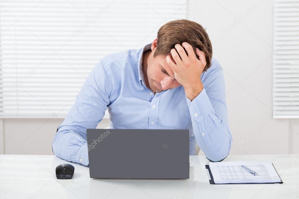 Stressed Businessman Using Laptop