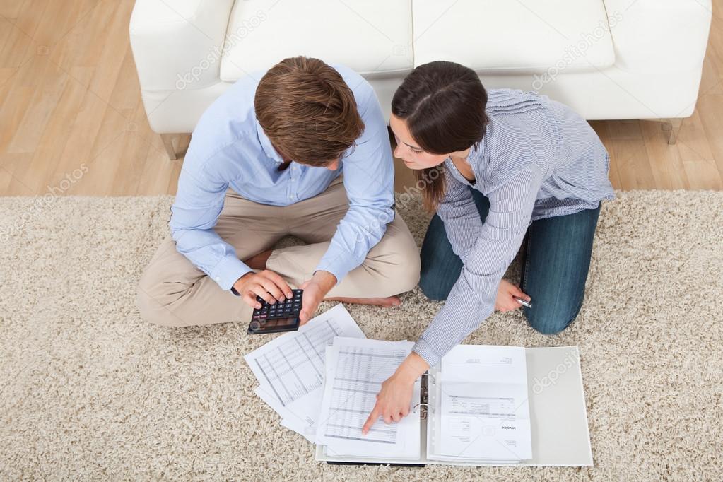 Couple Calculating Budget At Home