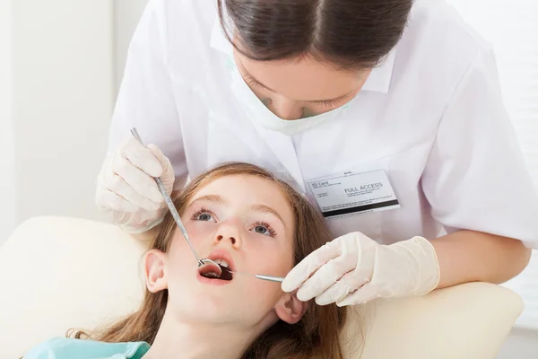 Tandläkare undersökande flicka mun — Stockfoto
