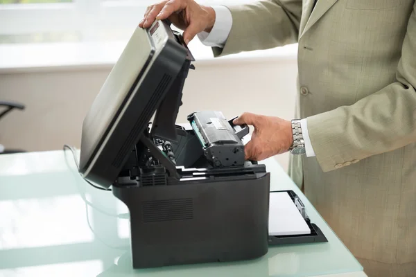 Businessman Fixing Cartridge — Stock Photo, Image