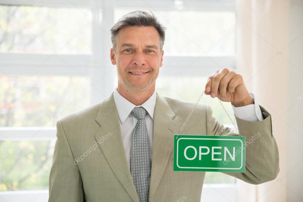 Businessman Holding Open Sign