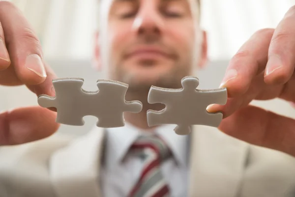 Businessman Connecting Together Puzzle — Stock Photo, Image