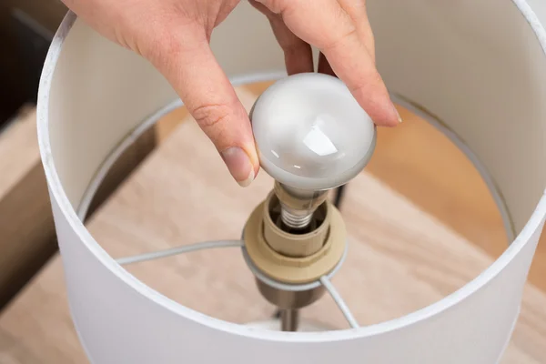 Woman Fixing Lamp — Stock Photo, Image