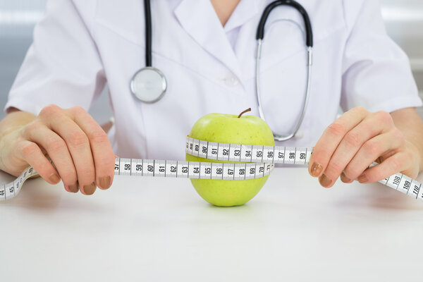 Dietician Measuring Green Apple