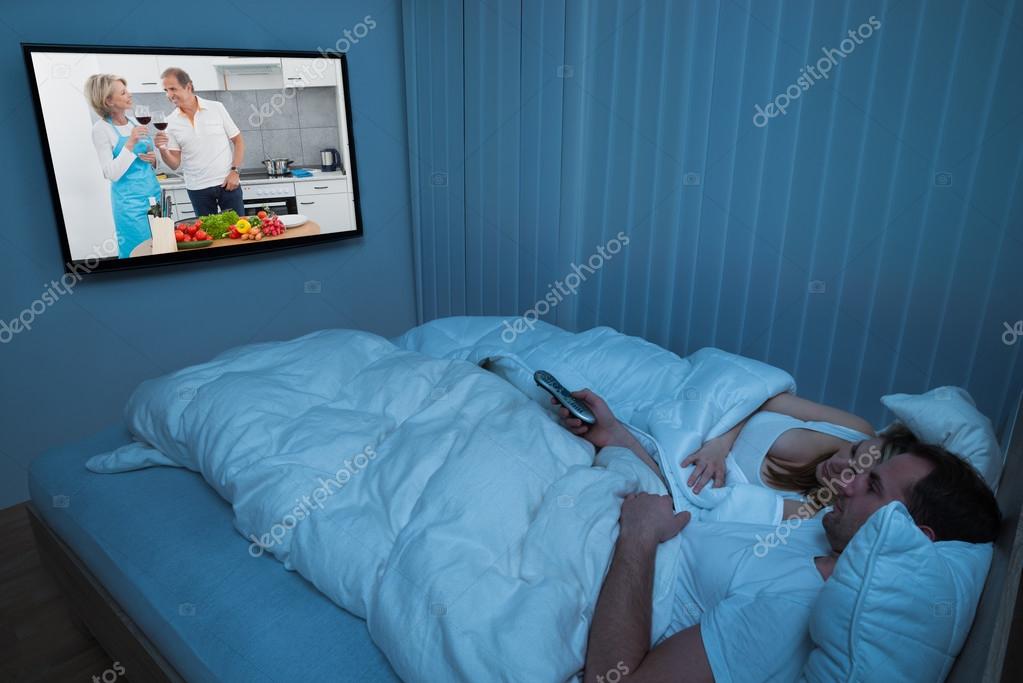 Couple With Blanket Watching Television — Stock Photo © AndreyPopov 72090287