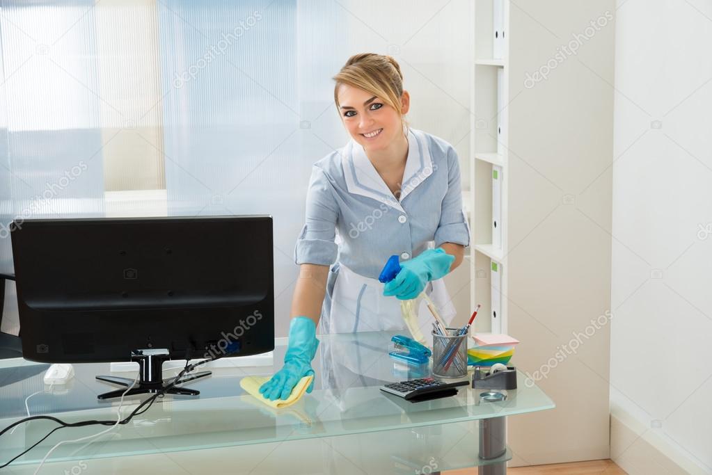 Maid Cleaning Desk In Office Stock Photo by ©AndreyPopov 72097215