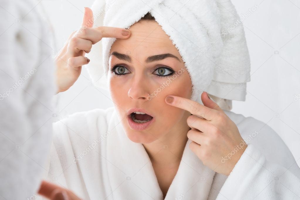 Woman Looking At Pimple
