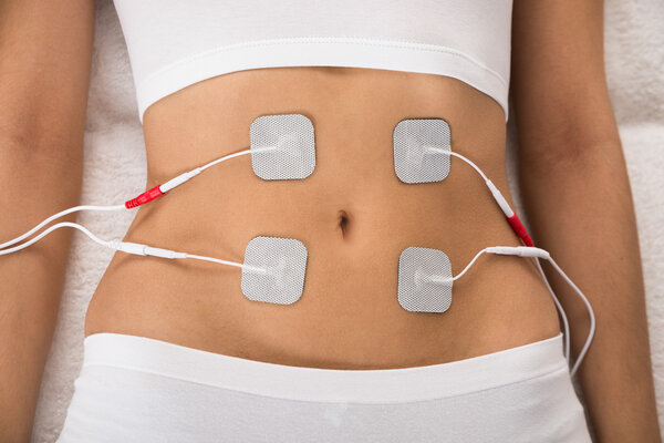 Woman With Electrodes On Stomach