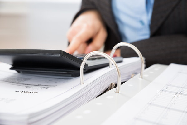 Businessperson Calculating Bills