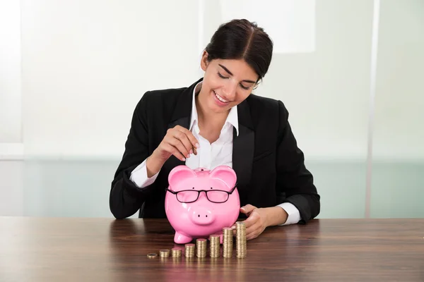 Businesswoman Inserting Coin — Stock Photo, Image