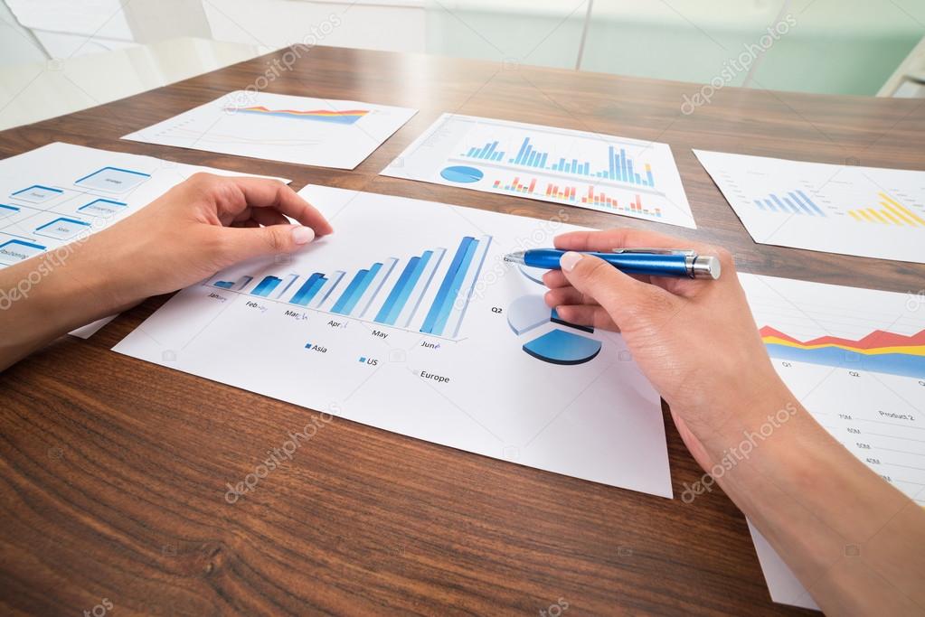 Businessperson Hands With Graphs