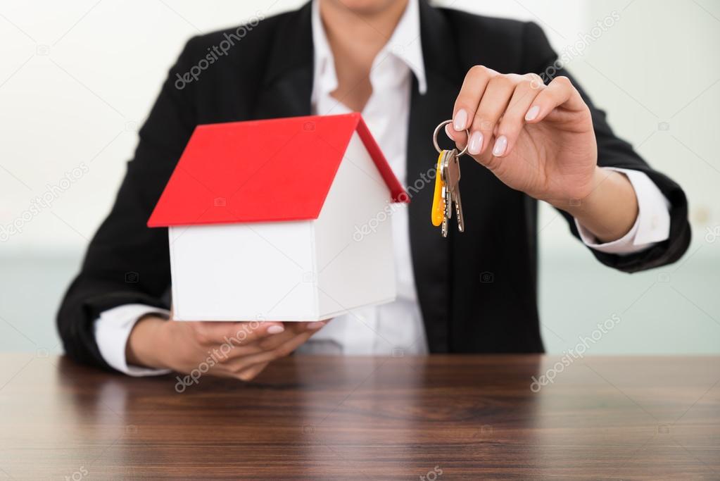 Businesswoman Holding House Model