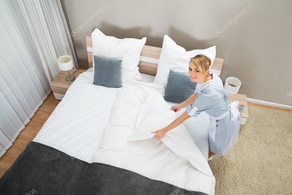 Housekeeper Making Bed