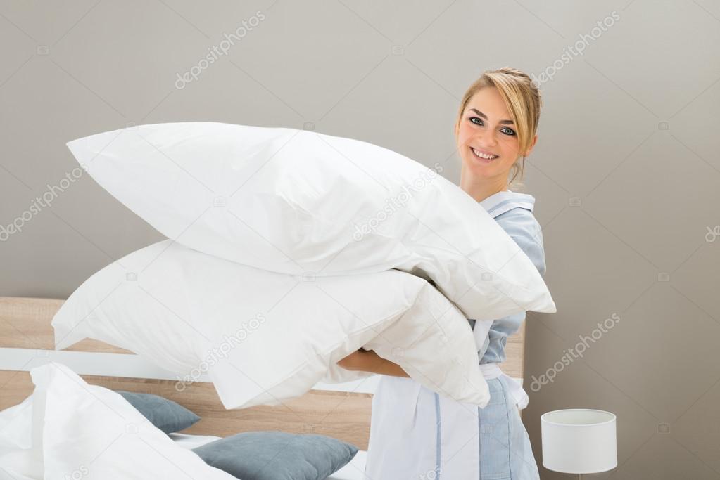 Housekeeping Worker With Pillows