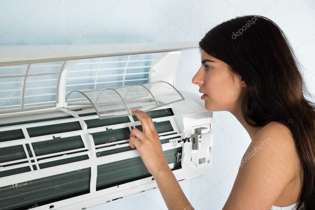 Woman Checking Air Conditioner