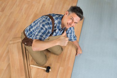 Worker Assembling Laminate Floor clipart