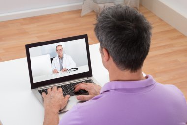 Man Having Video Chat With Doctor clipart