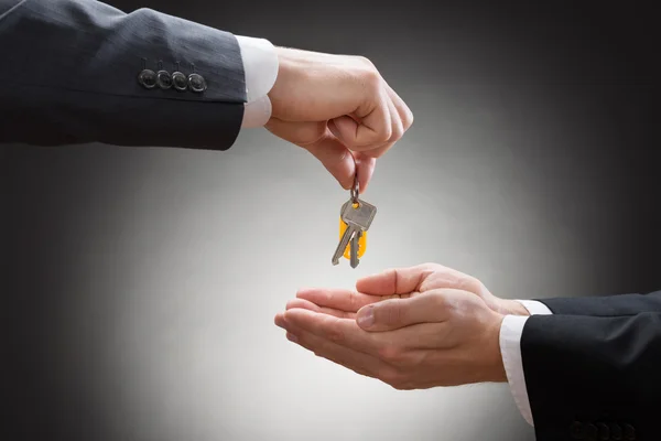 Businessman's Hand Giving House Key — Stock Photo, Image