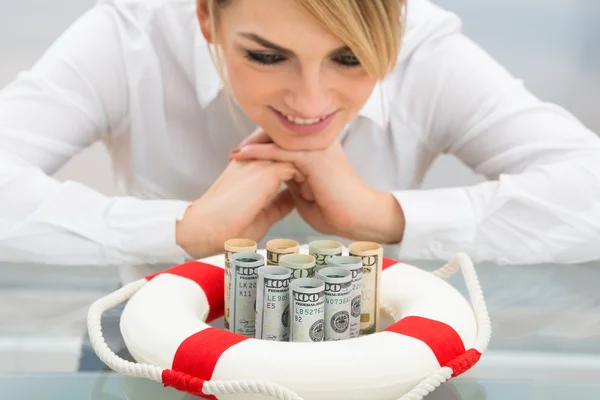 Businesswoman With Lifebuoy Protecting Banknotes — Stock Photo, Image