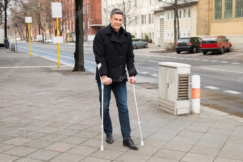 Man Walk Using Crutches — Stock Photo © AndreyPopov 73538223