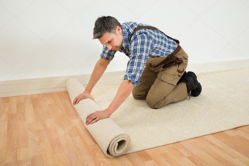 Worker Unrolling Carpet