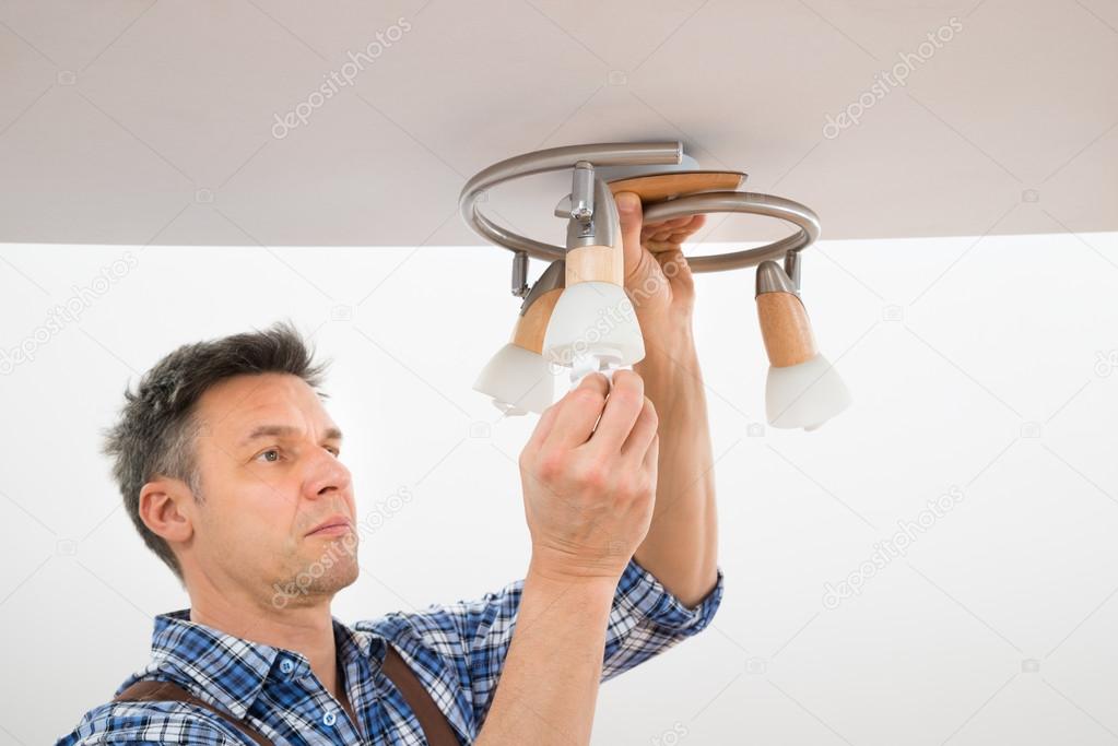 Technician Fixing Light