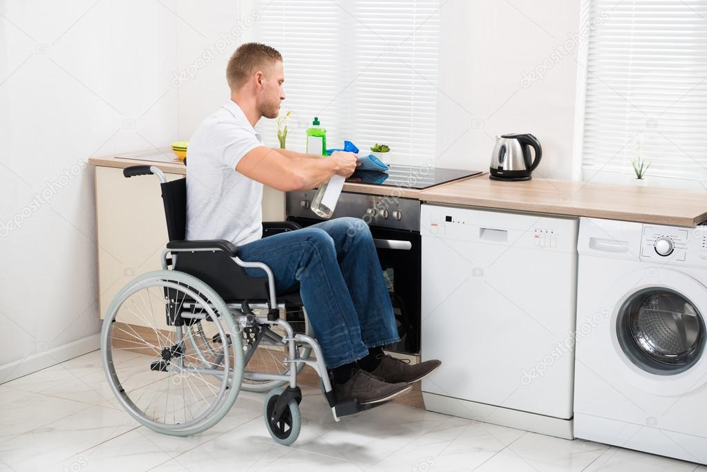 Handicapped Man Cleaning Stove