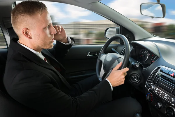 Affärsman med mobil i bil — Stockfoto