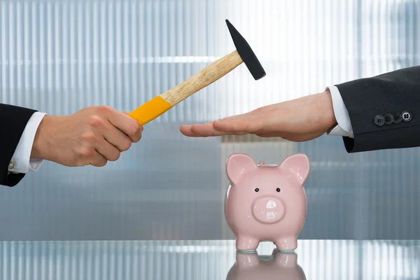 Businessman Saving Piggybank From Hammering — Stock Photo, Image