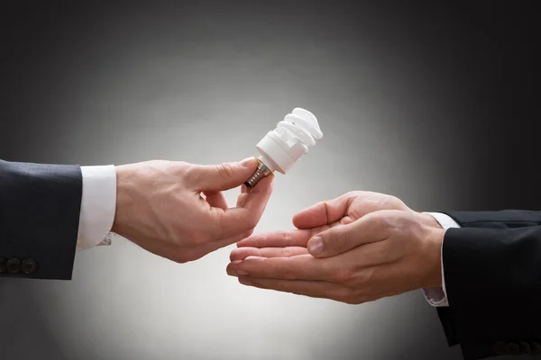 Businessperson Hand Offering  Light Bulb — Stock Photo, Image